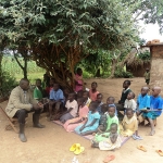 Pastor Wilson teaching several seated people in Uganda