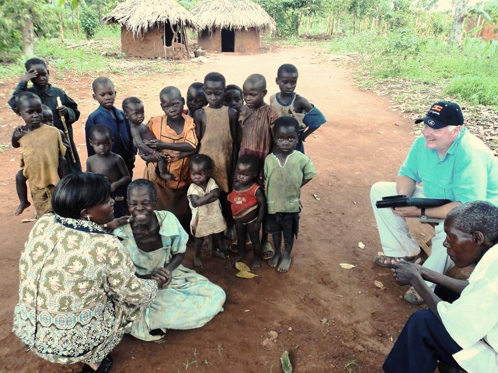 African children and women sitting under a tree