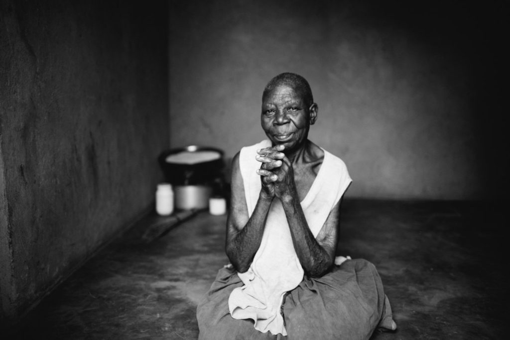 African woman sitting on the floor praying
